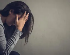 lady with head in hands