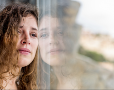 Woman leaning against window 