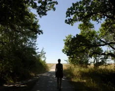 woman walking through a forest