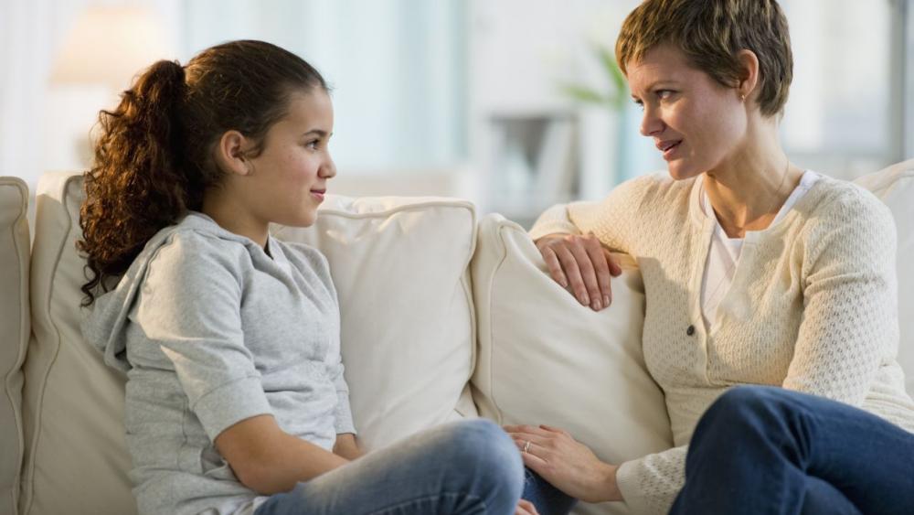 mom talking to a kid on couch