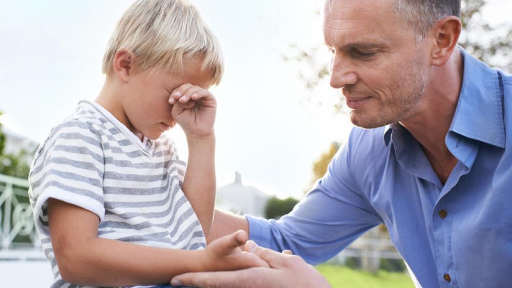 man helping son cope