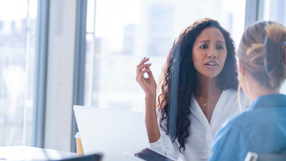 Two women in an office talking