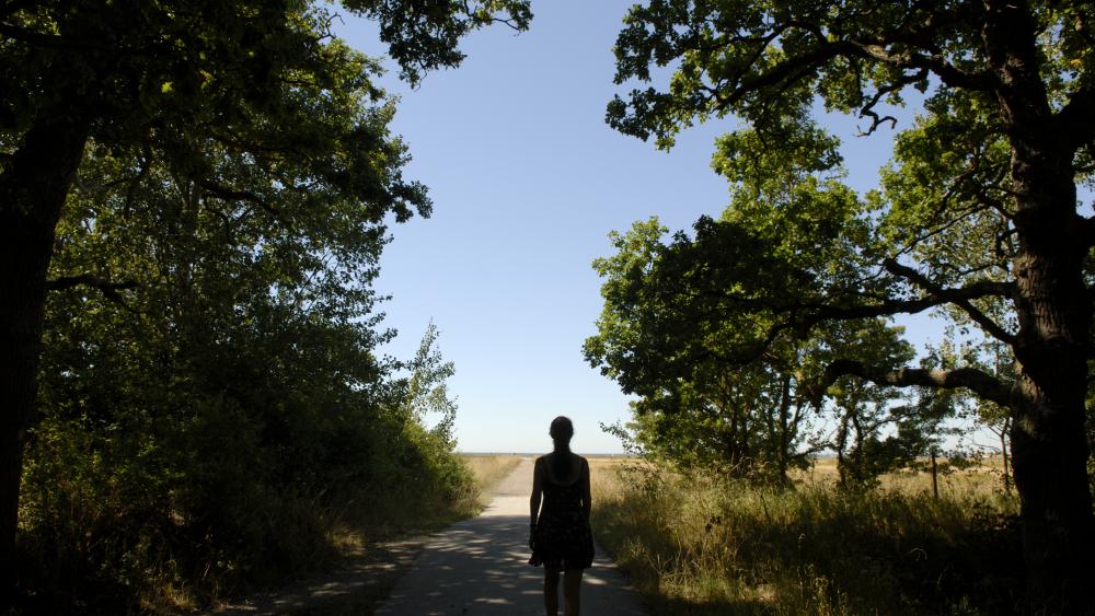 woman walking through a forest